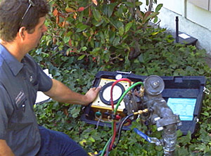 a League City irrigation repair tech is doing a backflow testing